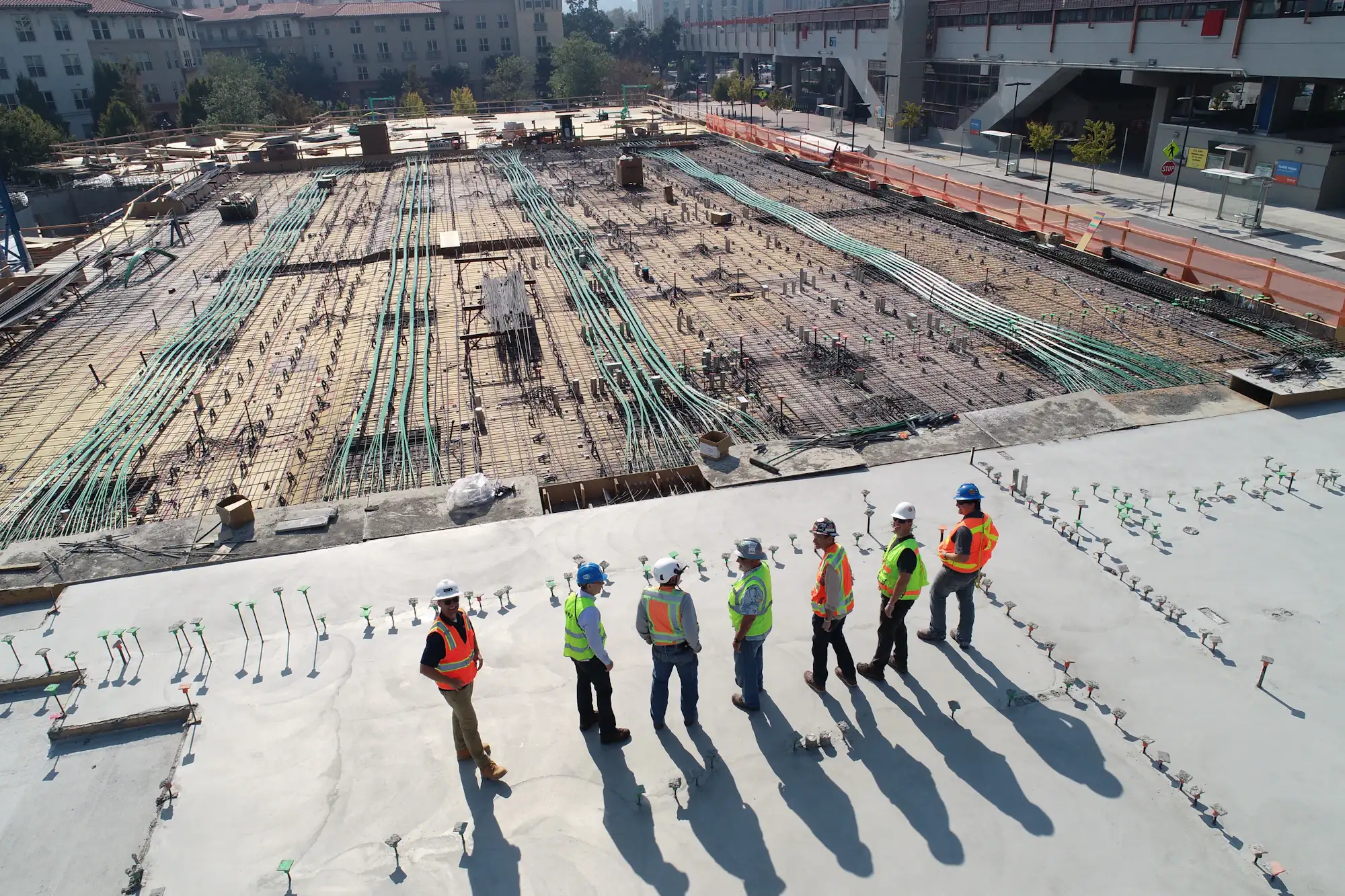 Construction team in hi-vis workwear on site at first light